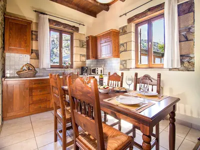 a kitchen with a wooden table and chairs at Falasarna Villas in Falasarna