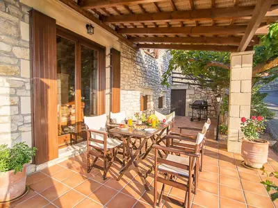 a wooden table and chairs on a patio at Falasarna Villas in Falasarna