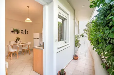 a kitchen and dining area of a house with plants at Sea Daffodil apartments in Kissamos