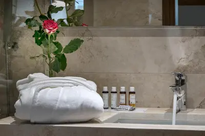 a bathroom sink with a towel and a rose at Villa Arhontariki in Kissamos