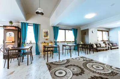 a living room with tables and chairs and a couch at Gregory Comfort Hotel in Kalamaki Chanion