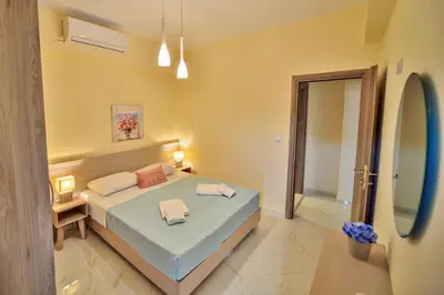 a bedroom with a bed with two towels on it at Aristea Apartments in Palaiochóra