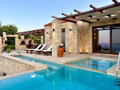 a swimming pool in front of a house at Villa Elena Chania in Karefilianá