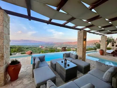 a patio with a view of a swimming pool at Villa Elena Chania in Karefilianá