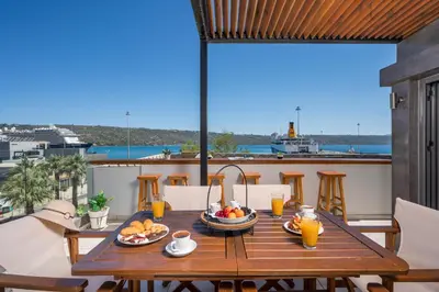 a table with food on top of a balcony at Nidus Villa in Souda