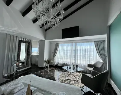 a living room with a chandelier and a couch at Mare suites 1 in Chania Town