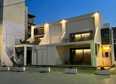 a large white building with its lights on at Mare suites 1 in Chania Town