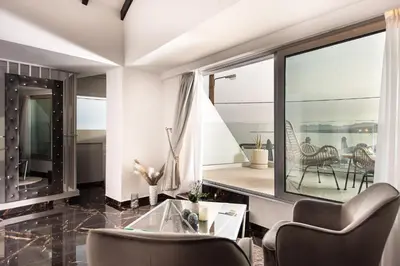 a living room with a glass table and chairs at Mare suites 1 in Chania Town