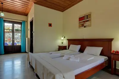 a bedroom with a large bed in a room at Heliopetra studios, small village close to beaches in Koprána
