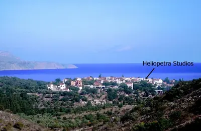 a town on a hill next to the water at Heliopetra studios, small village close to beaches in Koprána