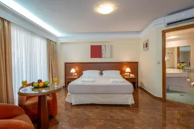 a hotel room with a bed and a table at Porto Alegre Hotel in Kalamaki Chanion