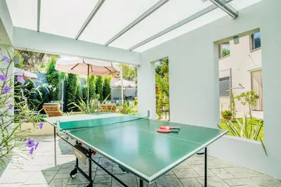 a ping pong table in a room with a patio at Villa Alyona in Skinés