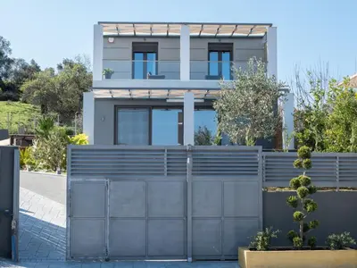 a house with a gate and a fence at Villa Alyona in Skinés