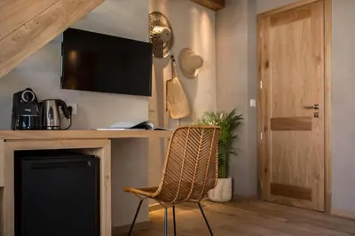 a room with a fireplace and a chair and a television at J&G Suites in Chania Town