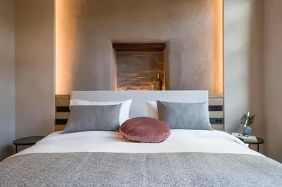 a bedroom with a large white bed with two pillows at J&G Suites in Chania Town