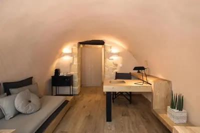 a room with a bed and a desk in a room at J&G Suites in Chania Town