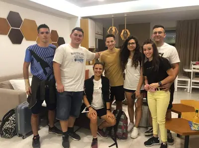 a group of people posing for a picture in a living room at Bee House in Kissamos