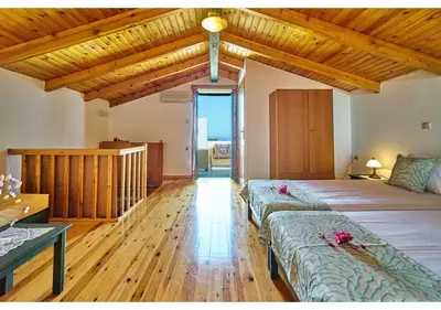 a bedroom with a large bed with flowers on it at Achilleas Apartments with Sea View in Kolymvari