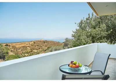 a bowl of fruit on a table on a balcony at Achilleas Apartments with Sea View in Kolymvari