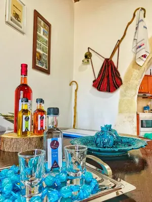 a kitchen counter with glasses and a bottle of alcohol at Evaggelias Home Gavalochori in Gavalochori