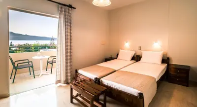 a bedroom with a bed and a balcony at Merabello Apartments in Agia Marina Nea Kydonias