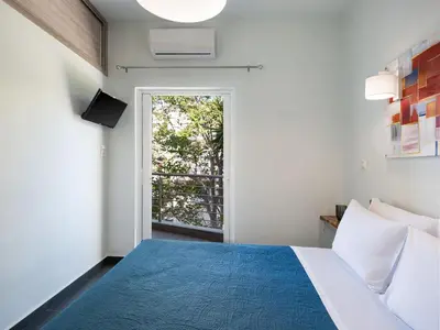a bedroom with a blue bed and a window at View Point Apartment in Chania Town