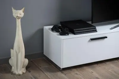 a white cat statue sitting on top of a white cabinet at Villa Sapphire in Almirida