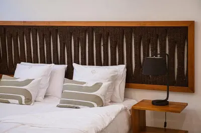 a bedroom with a bed with white pillows and a lamp at Villa Jamila by Cura Villas Collection in Kalathas