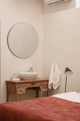 a bathroom with a sink and a mirror on a table at Villa Jamila by Cura Villas Collection in Kalathas