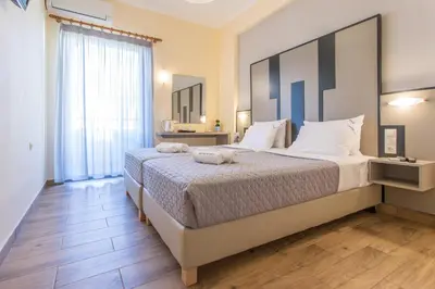 a bedroom with a large bed in a room at Glaros Hotel in Palaiochóra