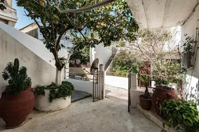a stairway with potted plants and trees in a building at Beach Studio next to the center in Kissamos
