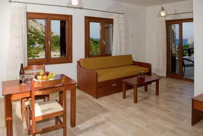 a living room with a couch and a table at Syia Hotel in Sougia