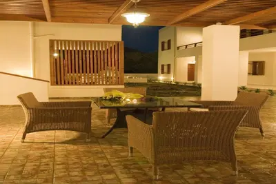 a patio with chairs and a table and a table and chairsktop at Syia Hotel in Sougia