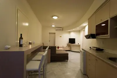 a kitchen and living room with a table and a couch at Seafalios in Kalamaki Chanion