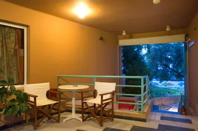 a dining room with a table and chairs and a window at Seafalios in Kalamaki Chanion