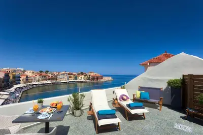 a patio with a view of the ocean on a house at 1924 suites in Chania Town