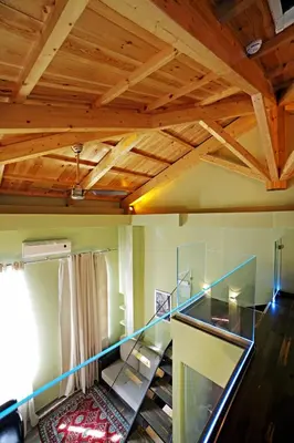 a living room with wooden ceilings and a glass staircase at Elia Fatma Boutique Hotel in Chania Town