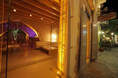 a building with a glass door with a table in a room at Elia Fatma Boutique Hotel in Chania Town