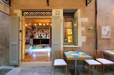 a restaurant with a table and chairs in front of a window at Elia Fatma Boutique Hotel in Chania Town