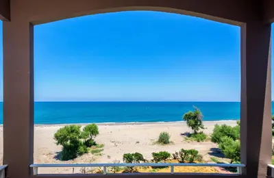 a view of the beach from a window at Matzi Hotel Apartments in Gerani Chanion