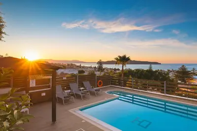 a pool on a balcony with a view of the ocean at Seaview Garden Villa - Heated Pool & Sauna in Stalos