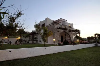 a house with a fence in front of a yard at Villa Merabello in Agia Marina Nea Kydonias