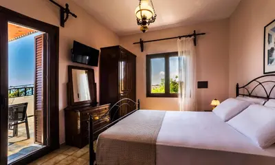a bedroom with a bed and a window at Villa Merabello in Agia Marina Nea Kydonias