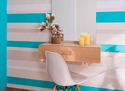 a white chair in front of a wall with a desk at Kalyves Maisonette Bougainvillea in Kalyves