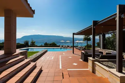 a house with a swimming pool with mountains in the background at Villa Thealassa - Hanging Over the Sea by etouri in Kounoupidhianá