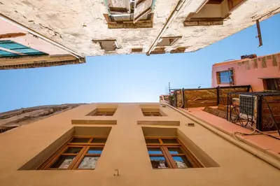 a tall building looking up at the sky at Portou House in Chania Town