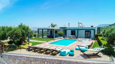 a villa with a swimming pool and a house at Mythic Olive villa - Heated Pool - Amazing view in Perivólia