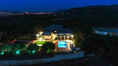 an aerial view of a house at night at Mythic Olive villa - Heated Pool - Amazing view in Perivólia