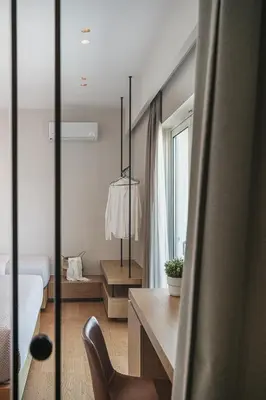 a bedroom with a bed and a desk with a chair at Theofilos City Hotel in Chania Town