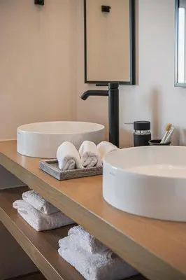 a bathroom with a sink and towels on a counter at Theofilos City Hotel in Chania Town